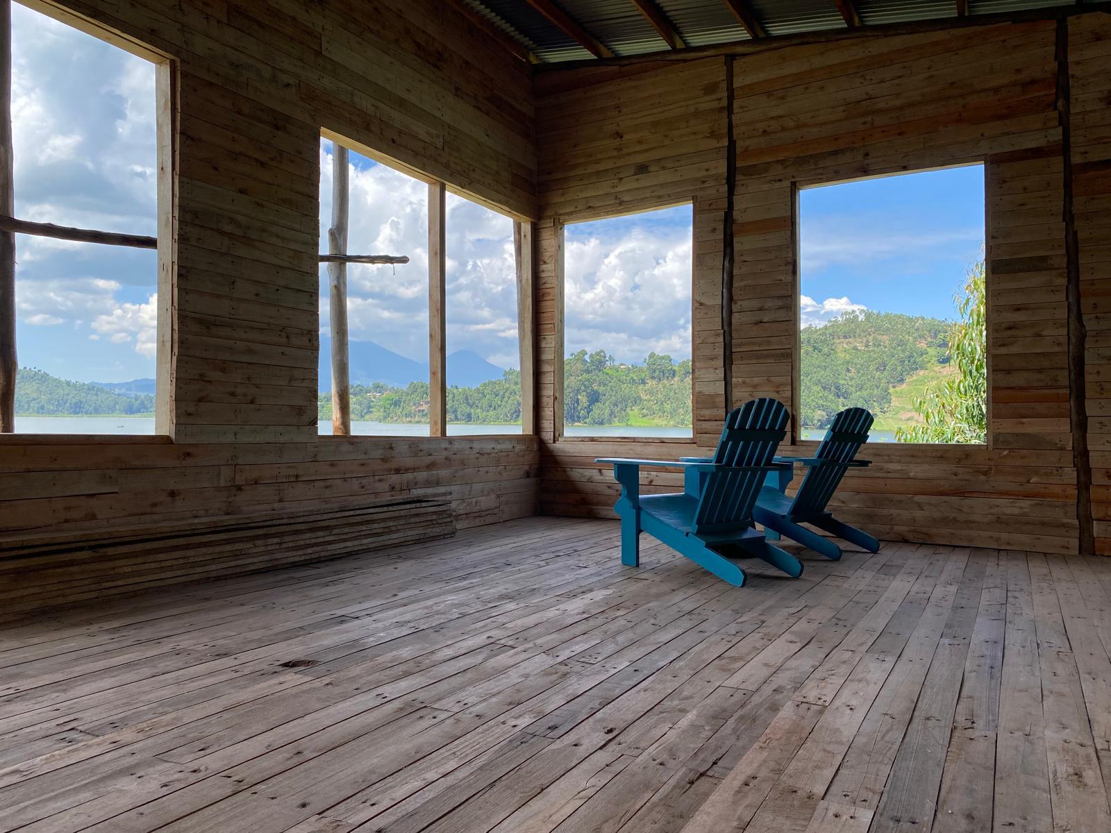 Veranda with two blue chairs facing the lake
